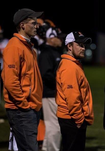 Jake Cross, ATC and Dr. Patrick Healy at a Brewer High School playoff football game